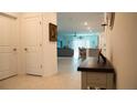 Bright hallway leading to an open floor plan with tile floors and neutral decor at 33891 Sky Blossom Cir, Leesburg, FL 34788