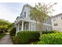 Attractive two-story home showcasing a covered porch, neat landscaping and views of a sidewalk at 351 Lansbrook Ln, Winter Springs, FL 32708