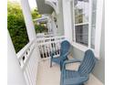 Cozy front porch featuring comfortable blue chairs and a view of the neighborhood at 351 Lansbrook Ln, Winter Springs, FL 32708