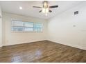 Bright and airy bedroom with hardwood floors, ceiling fan, and ample natural light from a window at 3600 Merryweather Dr, Orlando, FL 32812