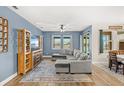Comfortable living room with a large sectional sofa, a ceiling fan, and plenty of natural light at 3632 Gretchen Dr, Ocoee, FL 34761