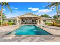 Outdoor pool with fountain feature and covered patio space, perfect for entertaining or enjoying the backyard at 3640 Crump Rd, Winter Haven, FL 33881