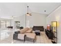 Spacious living room featuring tile floors, neutral paint, vaulted ceiling, and a ceiling fan with light at 3830 Spring Breeze Dr, Orlando, FL 32829