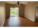 Bright living room with modern ceiling fan and sliding door to outdoor space at 5550 E Michigan St # 2114, Orlando, FL 32822