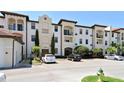 Exterior view of building with multiple units, balconies, and well-maintained landscaping at 5550 E Michigan St # 2202, Orlando, FL 32822