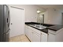 Efficient kitchen space equipped with stainless steel sink, dishwasher, and granite countertops at 5578 Metrowest Blvd # 10, Orlando, FL 32811
