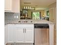 Stylish kitchen featuring granite countertops, white cabinets, and stainless steel appliances at 615 Clemson Dr, Altamonte Springs, FL 32714
