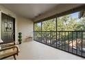 Screened-in balcony with seating offers an outdoor space with a view of trees and parking at 623 Dory Ln # 307, Altamonte Springs, FL 32714