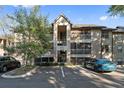 Apartment building exterior with a central stairwell entrance, balcony, and parking in front at 623 Dory Ln # 307, Altamonte Springs, FL 32714