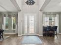 Welcoming foyer featuring wood-look floors, high ceilings, and an elegant front door at 645 American Holly Pl, Oviedo, FL 32765
