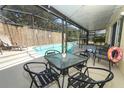 Backyard with outdoor seating, barbecue, and refreshing pool, all within a screened enclosure at 7834 Turkey Oak Ln, Kissimmee, FL 34747