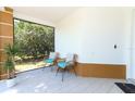 Inviting screened porch with stylish chairs, neutral tiling and a peaceful outdoor view at 7834 Turkey Oak Ln, Kissimmee, FL 34747