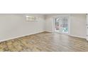Sunlit room with sleek wood floors and French doors to an outdoor space at 801 Fox Valley Dr, Longwood, FL 32779