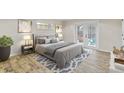 Stylishly furnished main bedroom with French doors leading to the backyard at 801 Fox Valley Dr, Longwood, FL 32779