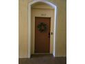 A brown front door with a wreath and smart lock at 8775 Sartori St # 302, Orlando, FL 32829
