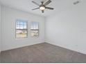 Neutral-toned bedroom with carpet and a ceiling fan at 1030 Alabaster Way, Deltona, FL 32725