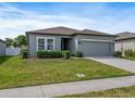 Beautiful one-story home featuring a well-maintained lawn and gray exterior with a two-car garage at 1030 Alabaster Way, Deltona, FL 32725
