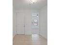 Bright foyer featuring neutral tile flooring and a view to an adjacent room at 1030 Alabaster Way, Deltona, FL 32725