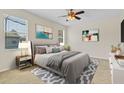 Comfortable bedroom with ceiling fan, neutral paint, and two windows at 1162 Lebanon Ct, Sanford, FL 32771