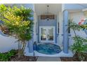 Inviting front entrance featuring double doors, blue accents, and decorative plants at 203 Prestwick Dr, New Smyrna Beach, FL 32168