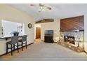 Inviting living room with stone fireplace, complemented by neutral carpet and a breakfast bar at 1037 Parnell Ct, Deltona, FL 32738
