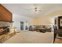 Spacious living room featuring a stone fireplace and comfortable seating at 1037 Parnell Ct, Deltona, FL 32738