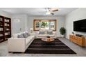 Inviting living room with large window, ceiling fan, comfortable seating, and stylish decor at 1212 Russell Dr, Ocoee, FL 34761