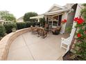 Inviting outdoor patio area featuring comfortable seating and a retractable awning for shade at 1669 Plum Branch Ter, The Villages, FL 32162