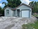 Charming single-story home featuring a gray exterior with a one-car garage and a well-maintained front yard at 2451 W 18Th St, Sanford, FL 32771