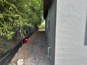 Side view of a gray house with a fence and green foliage at 2451 W 18Th St, Sanford, FL 32771