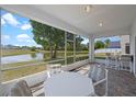 Relaxing screened-in porch with a scenic water view and outdoor seating, perfect for enjoying the peaceful surroundings at 408 Lexingdale Dr, Orlando, FL 32828