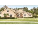 Charming single-Gathering home with manicured lawn and neatly trimmed hedges and beautiful light tan stucco at 452 Raccoon St, Lake Mary, FL 32746