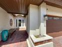 Inviting front porch with brick pavers, a cozy bench, and elegant entryway details at 7808 The Esplanade Ct, Orlando, FL 32836
