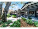Relaxing screened-in back patio with garden views and a shaded seating area at 1010 W Pebble Beach Cir, Winter Springs, FL 32708