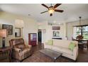 Comfortable living room with a ceiling fan, neutral colored walls, and tile floors at 11041 Se 169Th Pl, Summerfield, FL 34491