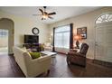 Spacious living room featuring tile floors, large windows, a ceiling fan, and comfortable seating at 11041 Se 169Th Pl, Summerfield, FL 34491