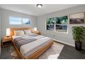 Bright bedroom with a large bed, soft bedding, and dual windows overlooking the outdoors at 1311 Bryn Mawr Ave, Lake Wales, FL 33853