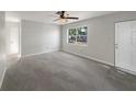Spacious, freshly painted living room with new carpet and lots of natural light from the large window at 1311 Bryn Mawr Ave, Lake Wales, FL 33853