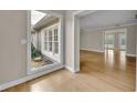 Bright living room with hardwood floors, natural light, and a serene garden view at 1370 Alberta Dr, Winter Park, FL 32789