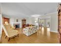 Cozy living room featuring hardwood floors, a fireplace, and ample natural light at 1370 Alberta Dr, Winter Park, FL 32789