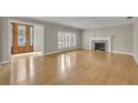 Spacious living room boasts hardwood floors, fireplace, and detailed glass front doors at 1370 Alberta Dr, Winter Park, FL 32789