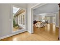 Bright living room showcasing hardwood floors and an open doorway to the adjacent room at 1370 Alberta Dr, Winter Park, FL 32789