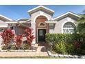 Attractive home entrance with decorative plants and a well-maintained walkway at 14021 King Sago Ct, Orlando, FL 32828