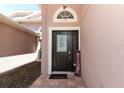 Welcoming front door featuring a decorative glass panel and a charming 'welcome' sign at 14021 King Sago Ct, Orlando, FL 32828