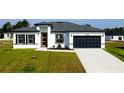 Attractive single-story home featuring well-kept landscaping, an attached garage, and concrete driveway at 15282 Sw 65Th Avenue Rd, Ocala, FL 34473
