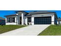 Inviting single-story home with a contemporary facade, concrete driveway, and attached two-car garage at 15282 Sw 65Th Avenue Rd, Ocala, FL 34473