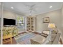 Cozy bedroom with hardwood floors, natural light, and built-in bookcase with a quiet spot to read and unwind at 1633 Pine Ave, Winter Park, FL 32789