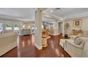 Open-concept living area with hardwood floors, view of the kitchen, and neutral decor perfect for relaxing or entertaining at 1633 Pine Ave, Winter Park, FL 32789