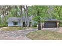 Charming single-story home featuring light blue siding and a brick-lined driveway at 1845 Spruce Creek Blvd, Port Orange, FL 32128