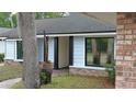 Charming home featuring light blue siding, black window trim and a brick-lined entrance at 1845 Spruce Creek Blvd, Port Orange, FL 32128